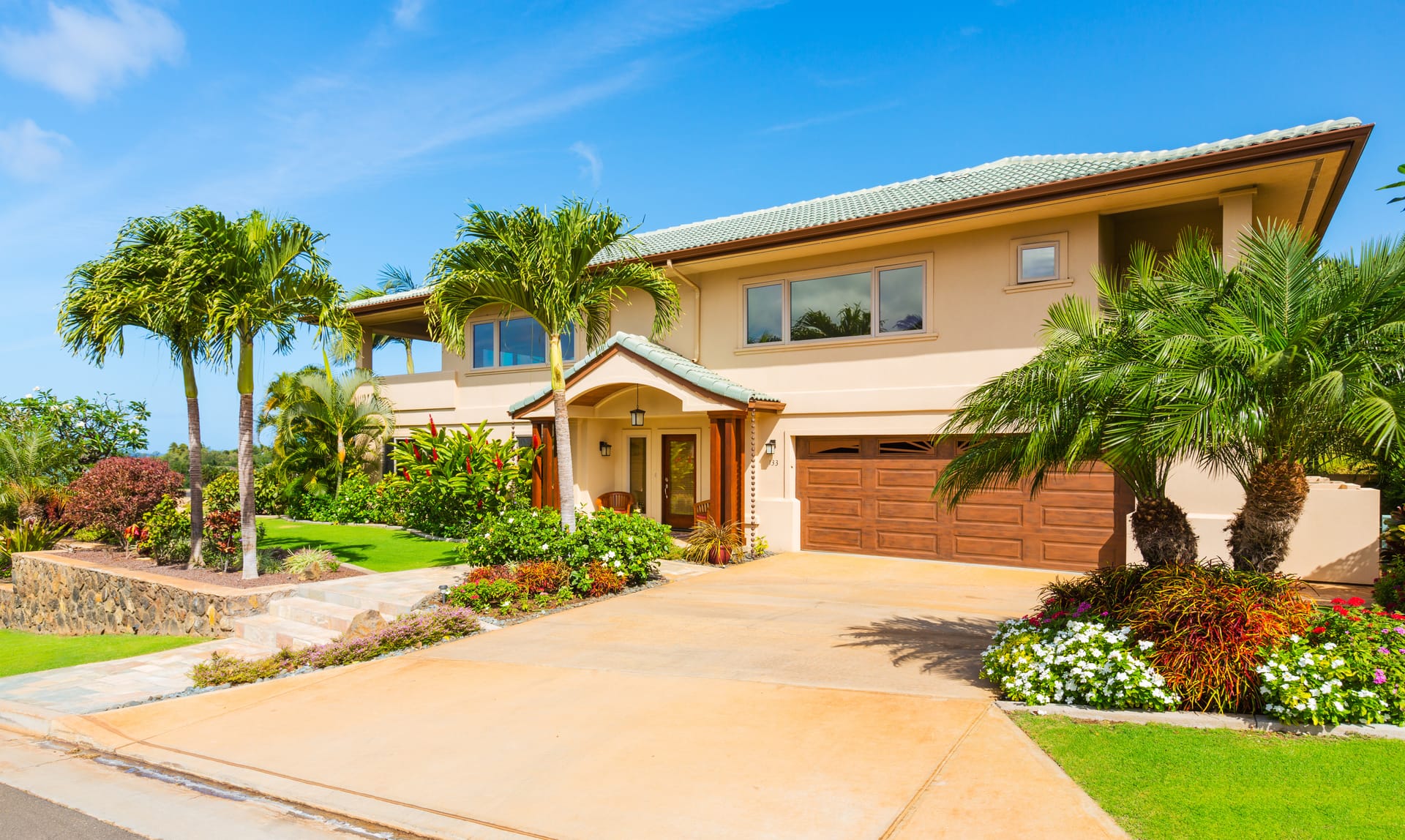 A stunning tropical landscape in front of a California home.